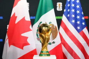Taça da Copa do Mundo ao lado das bandeiras dos países quevão sediar o torneio